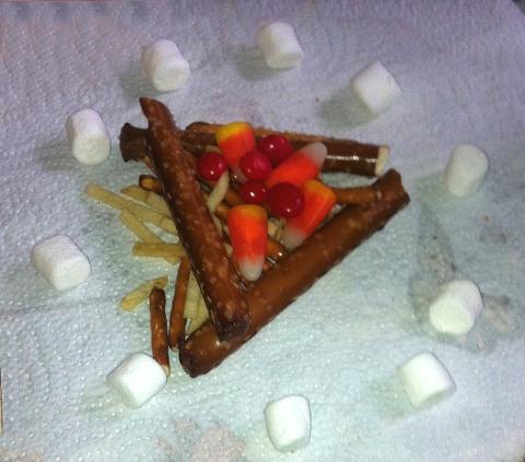 Campfire made of pretzels, potato sticks, candy corn, and marshmallows.