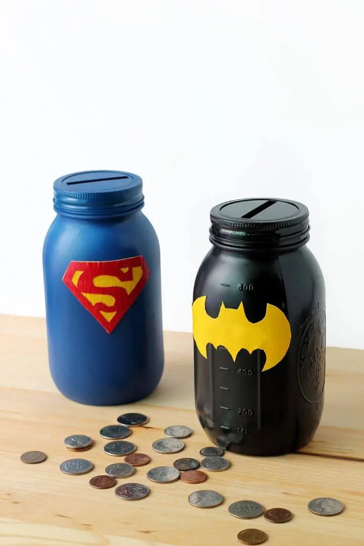 superman and bat man decorated painted jars with a coin slot. 