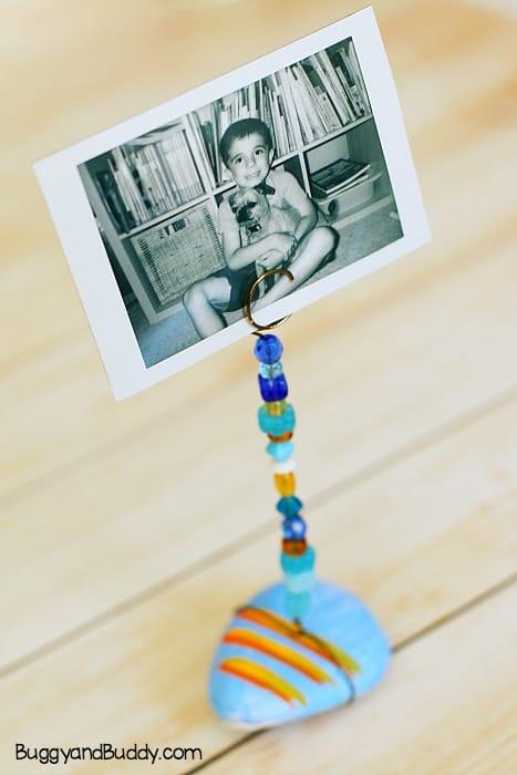 painted rock with a photo holder attached