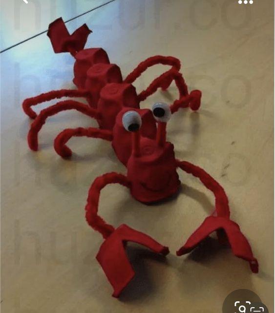 Lobster made out of egg cartons, pipe cleaners, and goggly eyes.